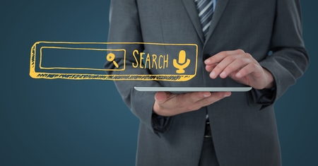 Digital composite of Business man mid section with tablet and yellow search bar against dark blue backgroundの写真素材