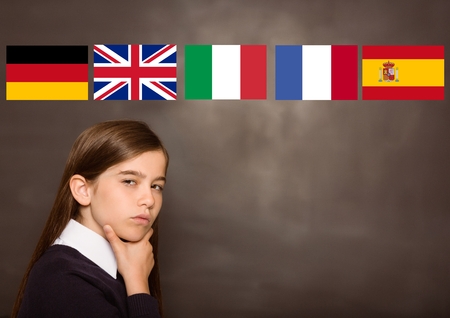 Digital composite of main language flags over girl, blackboard backgroundの写真素材