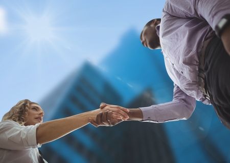 Digital composite of Business man and woman handshake . sky view. city.