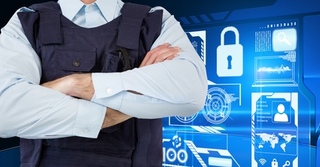 Digital composite of Policeman with his hands crossed standing on in front of digital wall