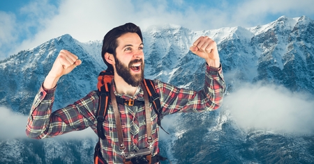 Digital composite of Happy rambler in front of snow-covered mountains backgroundの写真素材