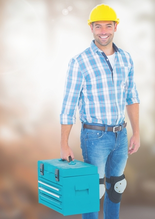 Digital composite of Construction Worker with tool box in front of construction siteの写真素材