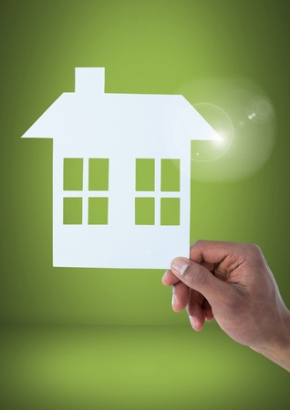 Digital composite of Cut out of house in handの写真素材