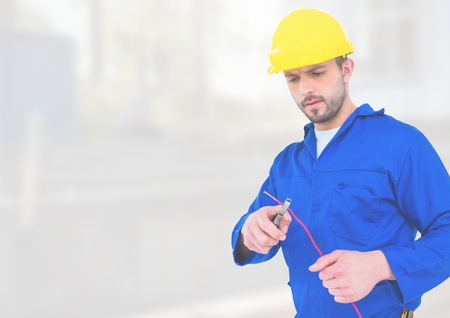 Digital composite of Electrician with wires cables on building site