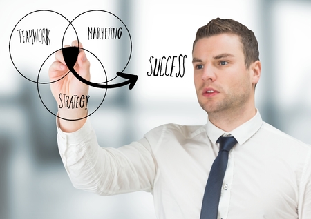 Digital composite of Business man drawing venn diagram doodle in blurry grey officeの写真素材