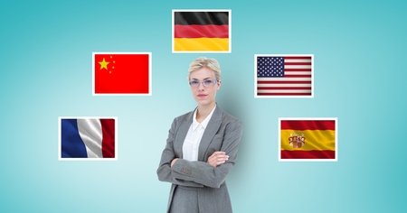 Digital composite of Portrait of businesswoman with arms crossed standing by flags against blue backgroundの写真素材