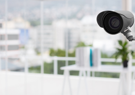 Digital composite of CCTV camera against defocused buildings