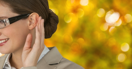 Digital composite of Cropped image of businesswoman against defocused lightsの写真素材