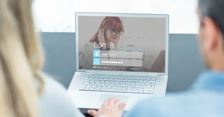 Digital composite of Cropped image of man and woman entering login password on laptopの写真素材