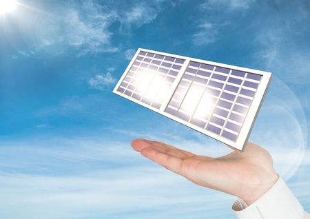 Digital composite of Digital image of solar panel on hand against skyの写真素材