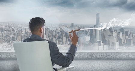 Digital composite of Rear view of businessman sitting on chair and smoking cigar while looking at cityの写真素材