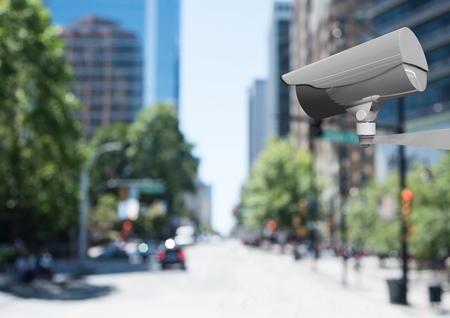 Digital composite of CCTV camera against defocused buildings