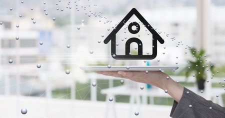 Digital composite of Hand holding digital tablet with home symbol and connecting dots