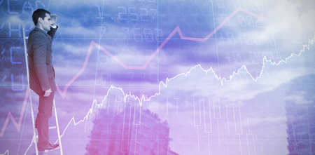 Businessman standing on ladder against stocks and sharesの写真素材