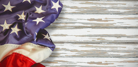 Creased US flag against wood backgroundの写真素材