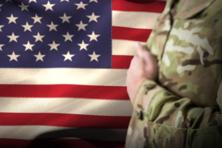 Mid section of military soldier taking oath against waving american flagの写真素材