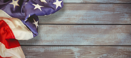Creased US flag against woodの写真素材