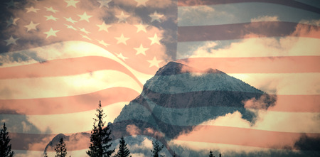 Digitally generated united states national flag against snowy mountain range against skyの写真素材