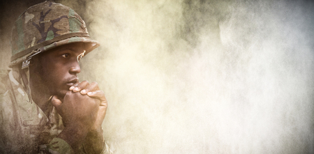 Close up of thoughtful military soldier against black wallの写真素材