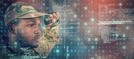 Close up of soldier saluting against dark roomの写真素材