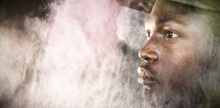 Close up of soldier looking away against black wallの写真素材
