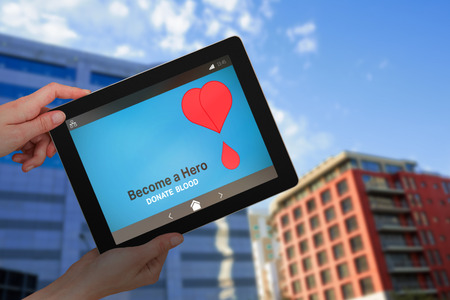 Hands holding digital tablet against white background against modern buildings against sky
