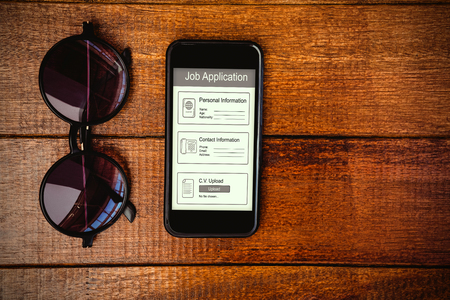 Informations for job application against view of glasses and a smartphoneの写真素材