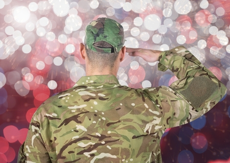 Digital composite of Military saluting against glowing backgroundの写真素材