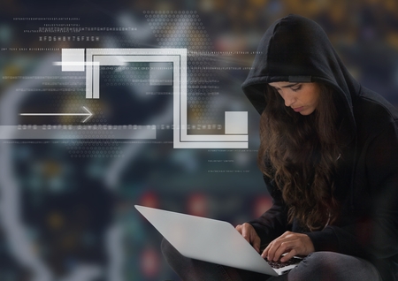 Digital composite of Woman hacker using a laptop in front of digital backgroundの写真素材