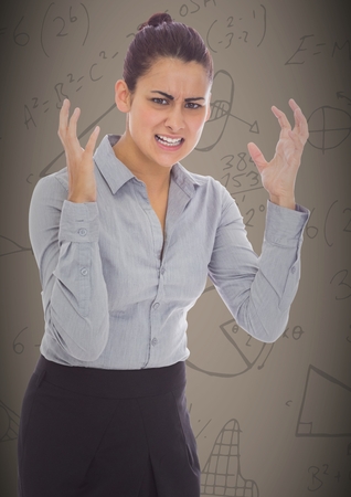Digital composite of Frustrated business woman against brown background and math graphicsの写真素材