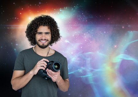Digital composite of Photographer holding a camera against galaxy backgroundの写真素材