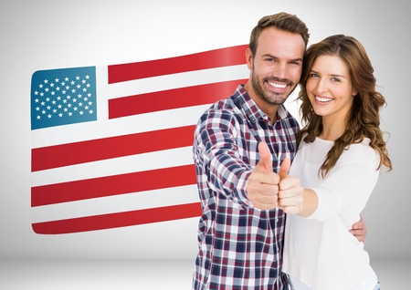 Digital composite of Couple thumbs up on american flag backgroundの写真素材