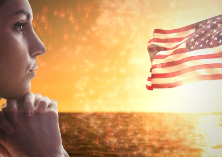 Digital composite of Woman thinking against sea and american flagの写真素材