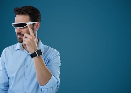 Digital composite of Man in virtual reality headset against blue backgroundの写真素材