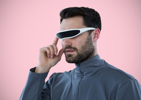 Digital composite of Man in virtual reality headset against pink background