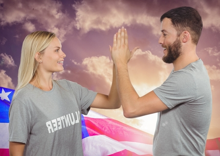 Digital composite of Couple high fiving against american flagの写真素材