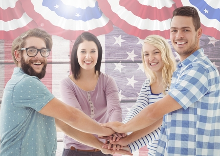 Digital composite of Smiling Friends with hands together against american flagの写真素材