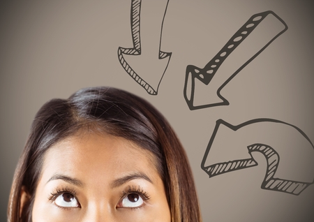 Digital composite of Top of woman's head looking up at downward arrows against brown backgroundの写真素材
