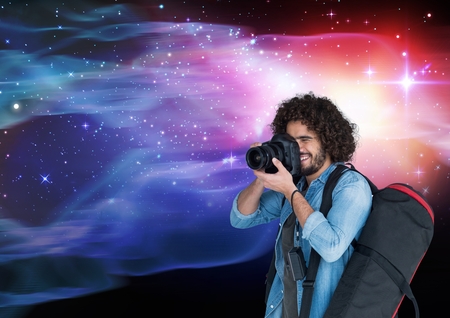 Digital composite of Photographer taking pictures against galaxy background