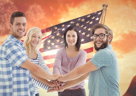 Digital composite of Friends with hands together against american flagの写真素材