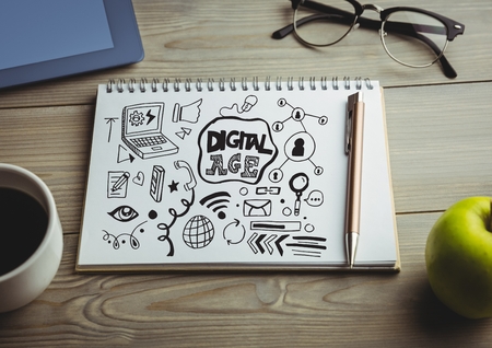 Digital composite of Digital age doodle on notepad on desk with coffee and appleの写真素材