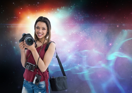 Digital composite of Photographer holding camera  against galaxy backgroundの写真素材
