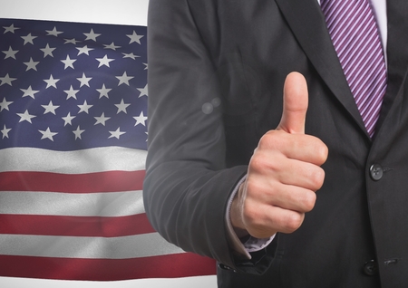 Digital composite of Business man with thumb up against american flag