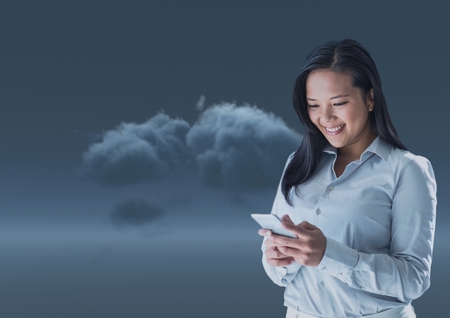 Digital composite of Smiling woman texting in 3D darknessの写真素材