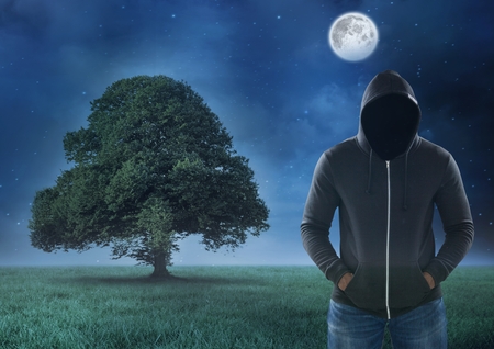 Digital composite of Hacker standing on in front of  fieldの写真素材