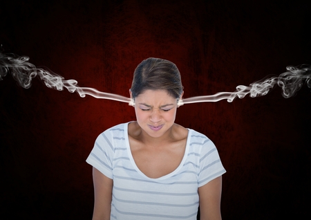 Digital composite of anger young woman with 3D steam on ears. Black and red background