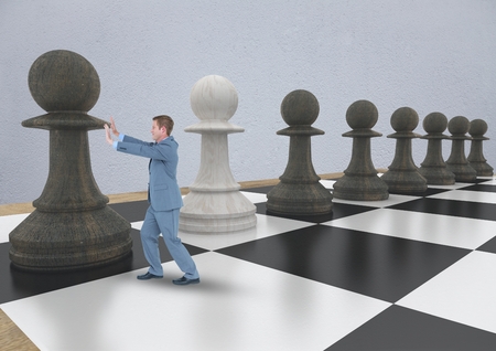 Digital composite of Business man pushing 3D chess piece against grey wallの写真素材