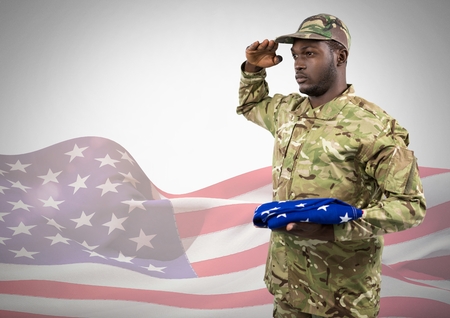Digital composite of Black soldier holding an american flag for independence day against a 3d american flagの写真素材