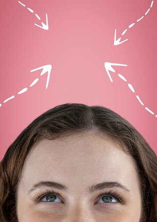 Digital composite of Woman looking up at white arrows against pink backgroundの写真素材