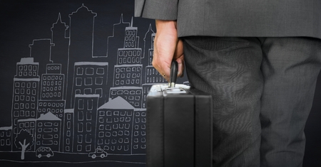 Digital composite of Business man lower body with briefcase against navy background with city doodleの写真素材